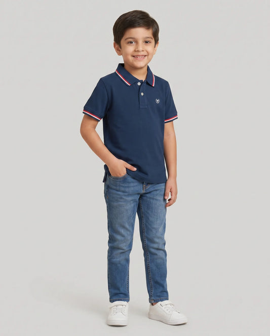 Boys navy blue polo t-shirt close-up of embroidered Kidley crest badge