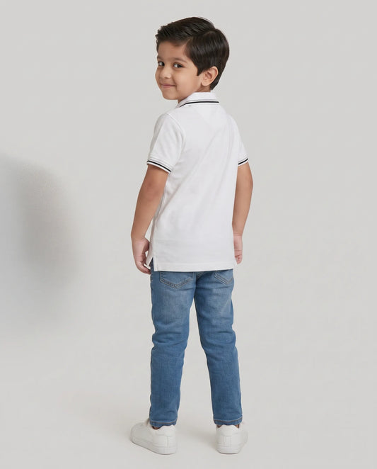 Boys white polo t-shirt close-up of embroidered Kidley crest badge